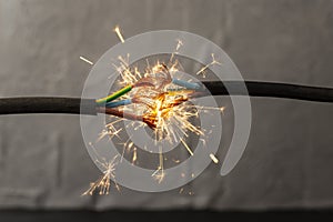 sparks explosion between electrical cables, fire hazard concept