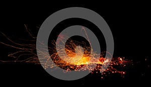 Sparks from the fire embers explosion on a black background