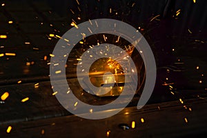 Sparks are generated during welding process of argon gas to steel at factory area