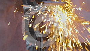 Sparks from grinding a part on a grinding wheel. Processing a metal part on a grinding wheel. Bright sparks from