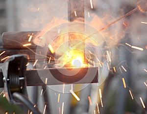 Sparks and jets of smoke when welding