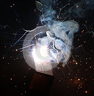 Sparks and jets of smoke when welding