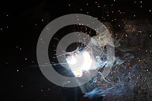 Sparks and jets of smoke when welding