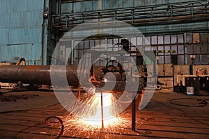 Sparks from a metal cutting machine in a factory.