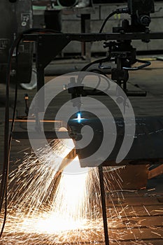 Sparks from a metal cutting machine in a factory.