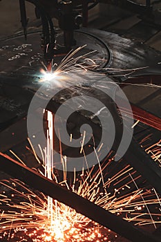 Sparks from a metal cutting machine in a factory.