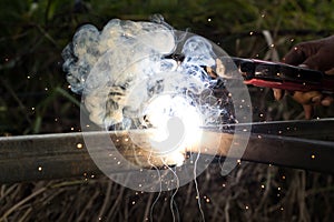 Sparks and smoke welding iron.