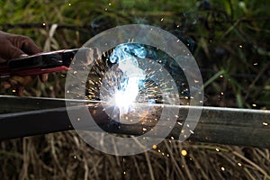 Sparks and smoke welding iron.