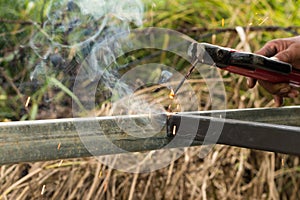 Sparks and smoke welding iron.