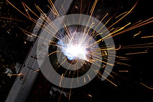 Sparks from welding at a construction site as a background