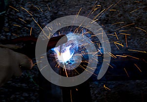 Sparks from welding at a construction site as a background