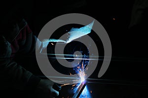 Sparks from welding. A man will weld metal. Workplace of the welder. Garage welder