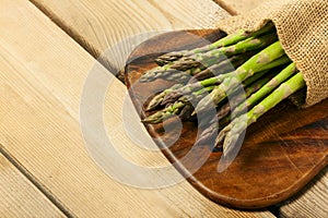 Sparrow grass. Fresh green asparagus on black slate background. Top view copy space photo