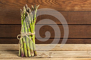Sparrow grass. Fresh green asparagus on black slate background. Top view copy space photo