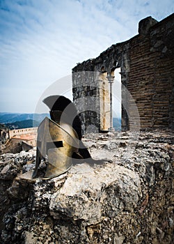 Spartan helmet on castle ruins