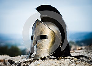 Spartan helmet on rocks.