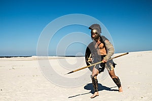 Spartan quickly runs through the sand photo