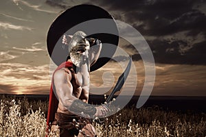 Spartan warrior going forward in attack with sword.