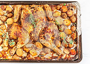 Spatchcocked barbecue chicken with Potatoes on a Baking Tin