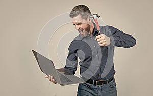 Spate of cyberattack. Hacker assaulting computer with hammer. Targeted cyberattack photo