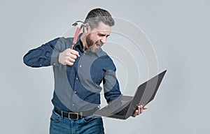 Spate of cyberattack. Hacker assaulting computer with hammer. Targeted cyberattack photo