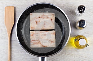 Spatula, frozen pollock in frying pan, vegetable oil, salt, pepper