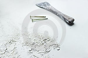 Spatula nails and dried crushed putty lime on white background