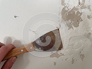 Spatula on a wall while fixing in a room