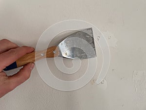 Spatula on a wall while fixing in a room