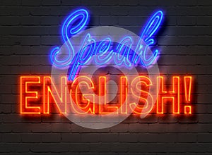 Speak English, neon sign on brick wall