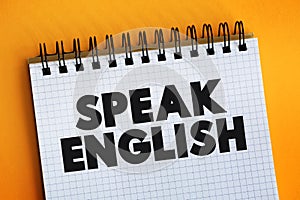 Speak English text on notepad, education concept background