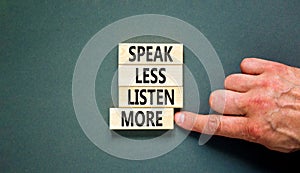 Speak less listen more symbol. Concept words Speak less listen more on wooden block. Beautiful grey table grey background.