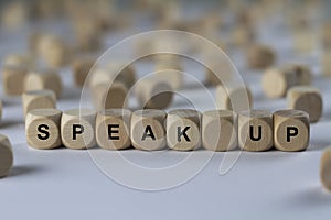 Speak up - cube with letters, sign with wooden cubes photo