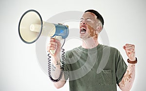 Speak up, even if your voice shakes. Studio shot of a young man with vitiligo using a megaphone against a white