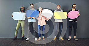 Speak your mind. Studio shot of a diverse group of people holding up speech bubbles against a gray background.