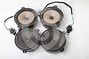 Speaker of an acoustic system an audio for playing music in a car interior on a white isolated background in a photo studio. Spare
