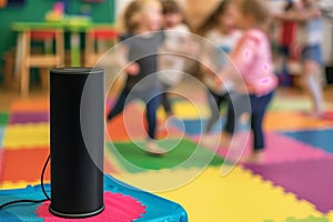 speaker on a colorful mat, blurry toddlers wiggling to nursery rhymes photo