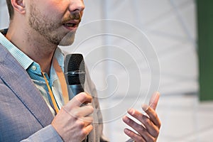 Speaker at conference holding microphone