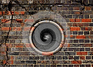 Speaker on a cracked brick wall background