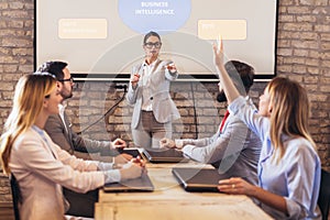 Speaker giving public presentation using projector in conference room photo