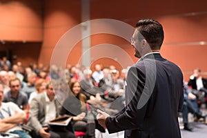 Speaker giving talk at business conference event.