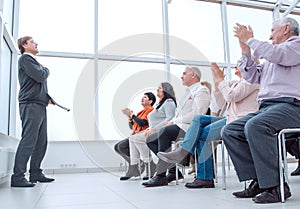 Speaker giving a talk in conference hall at business event. Audi