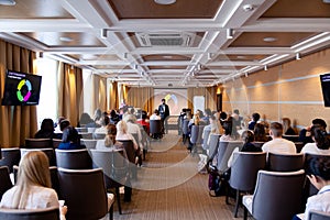 Speaker giving a talk at conference, presentation, business event. Audience at the conference hall. Business and entrepreneurship