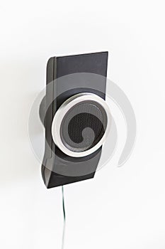 Speaker mounted on a white wall. Part of the home theater 5 to 1