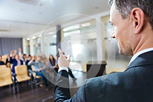 Speaker pointing to audience on business conference