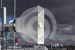 Speaker speaker and red signal lights on the roof of a high-rise building, warning system for high-rise situations