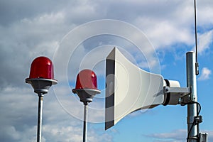 Speaker speaker and red signal lights on the roof of a high-rise building, warning system for high-rise situations