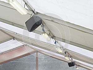 Speakers and neon lights on the ceiling of tensile structure