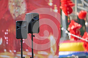 speakers and stand in front of stage ,concert show outdoors daytime