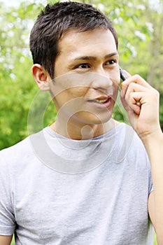 Speaks on a mobile phone